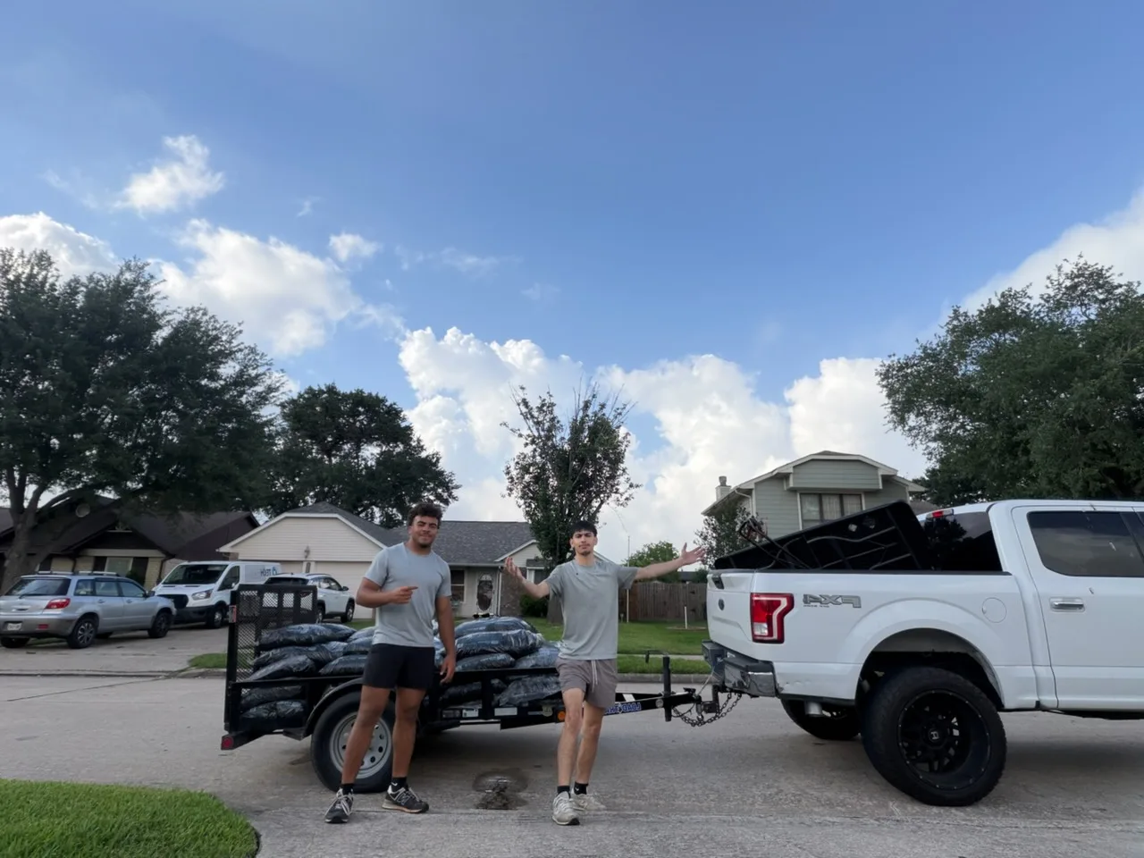 The Landscape Genius crew with a trailer loaded with mulch for a job