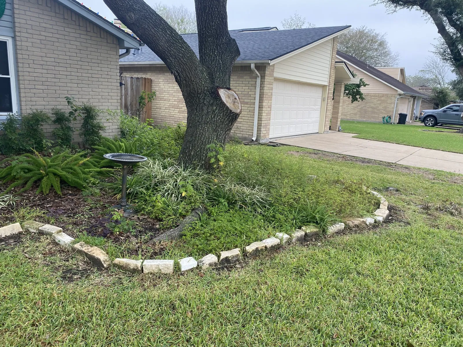 Front yard bed with a stone border and fresh mulch